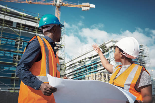 Project managers reviewing plans on site